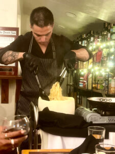 Cacio e Pepe prepared tableside in a wheel of Parmesan at Puglia