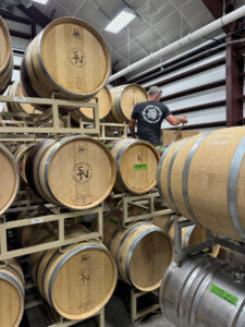 Man working Wine Casks at the Sycamore Ranch Vineyard and Winery