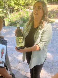 Woman holding bottle of wine at the Sycamore Ranch Vineyard and Winery