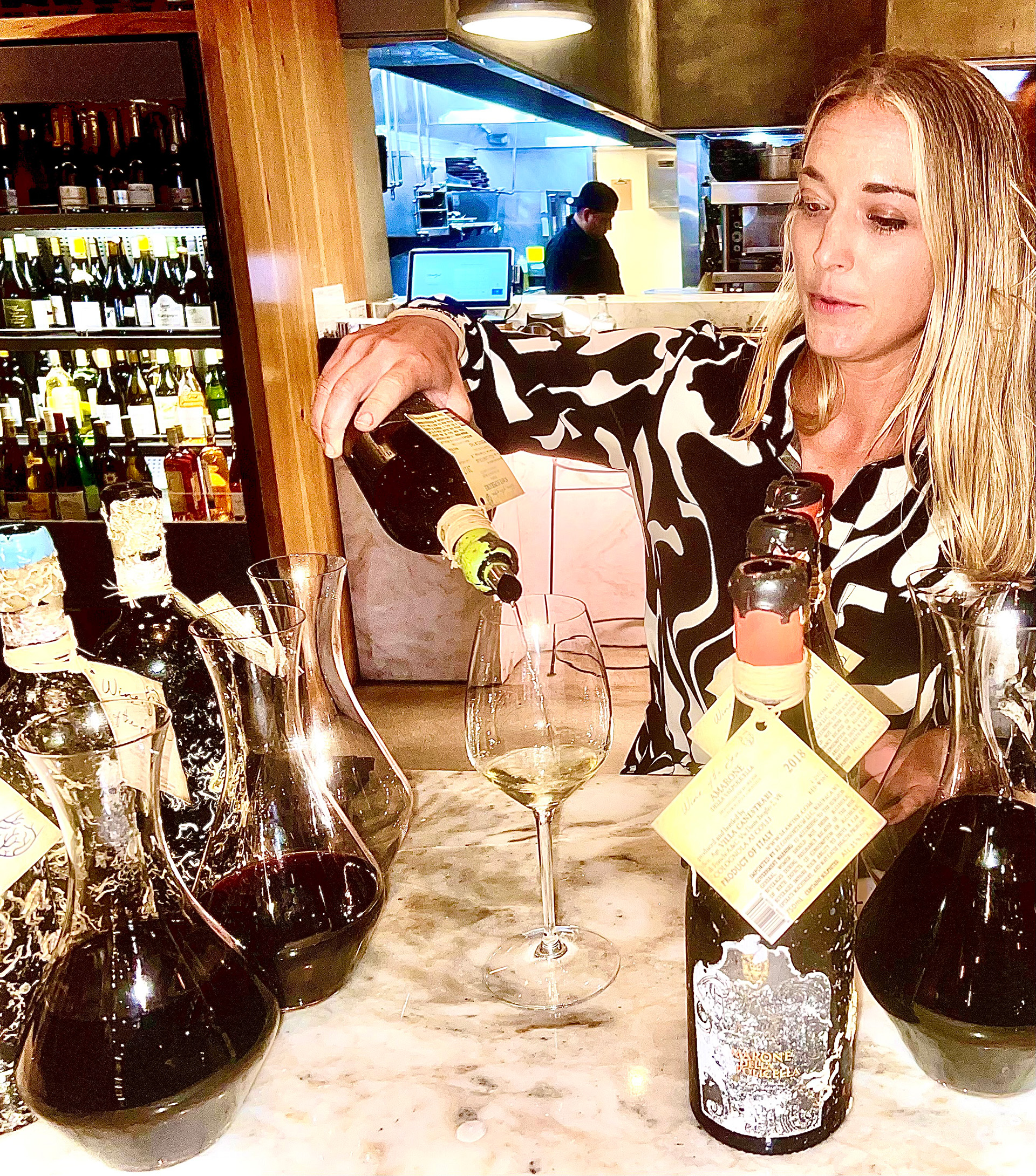 Woman pouring wine at Wally's