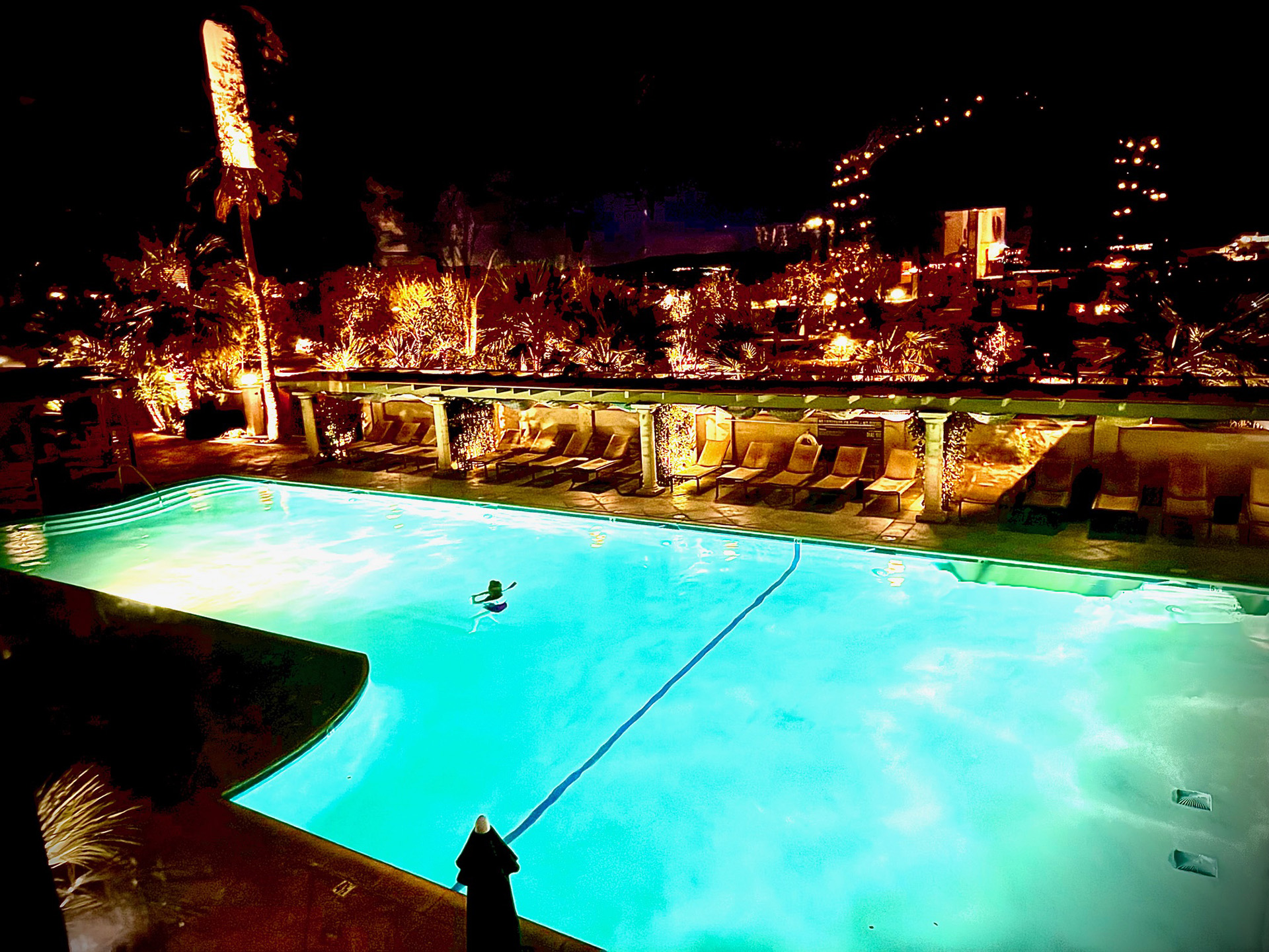 Nighttime pool and cabana scene at Miracle Springs Spa