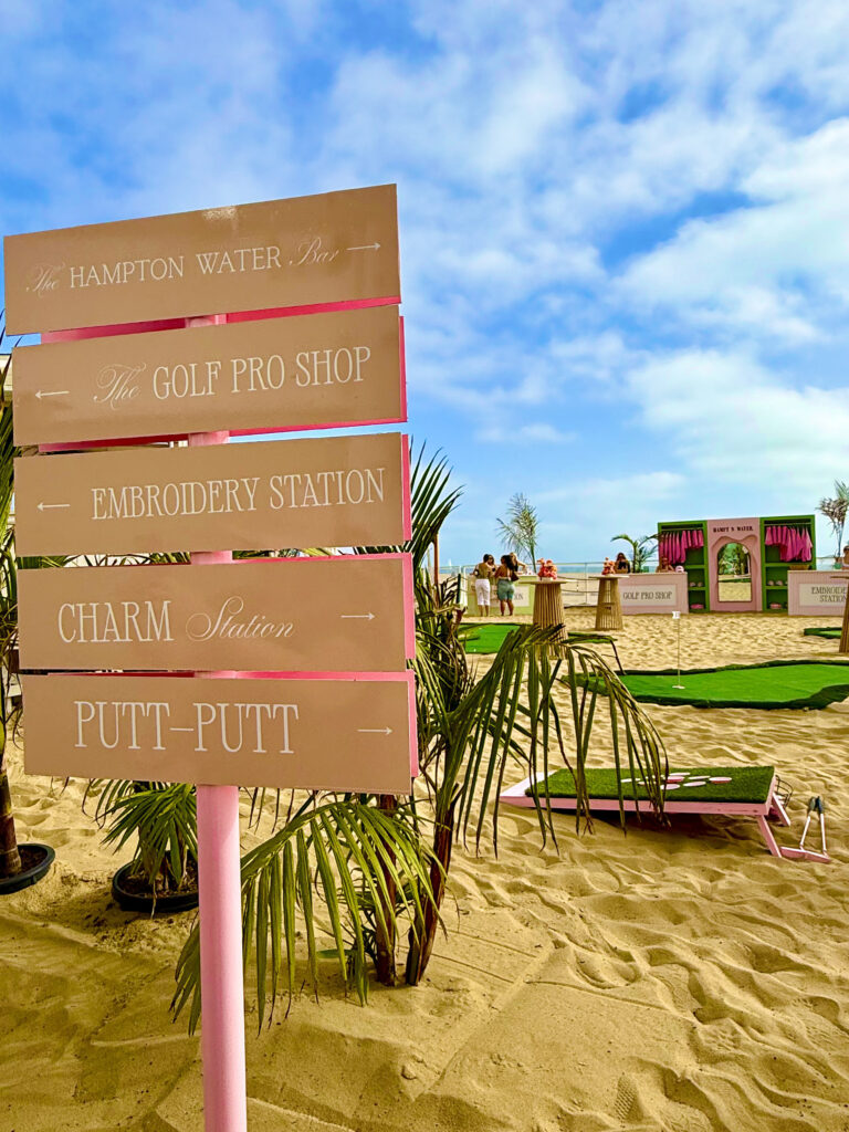 Signs pointing to Hampton Water Bar, Golf Pro Shop, Embroidery Station, Charm Station and Putt-Putt