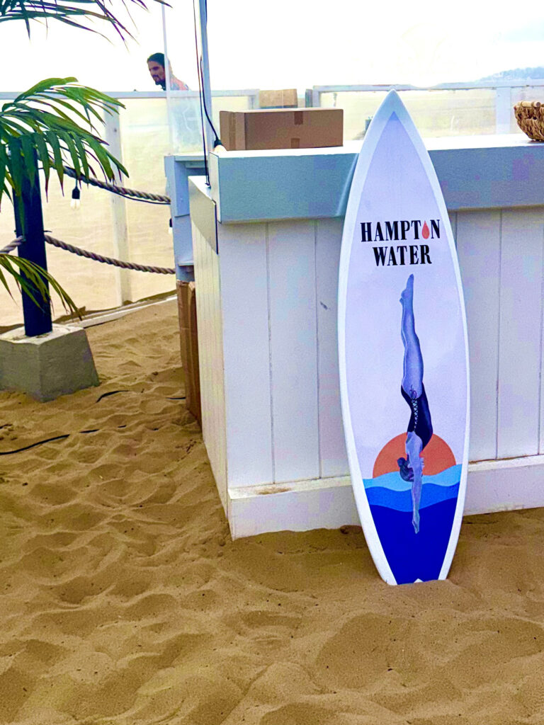 Surfboard featuring the Hampton Water logo and an illustration of a diver