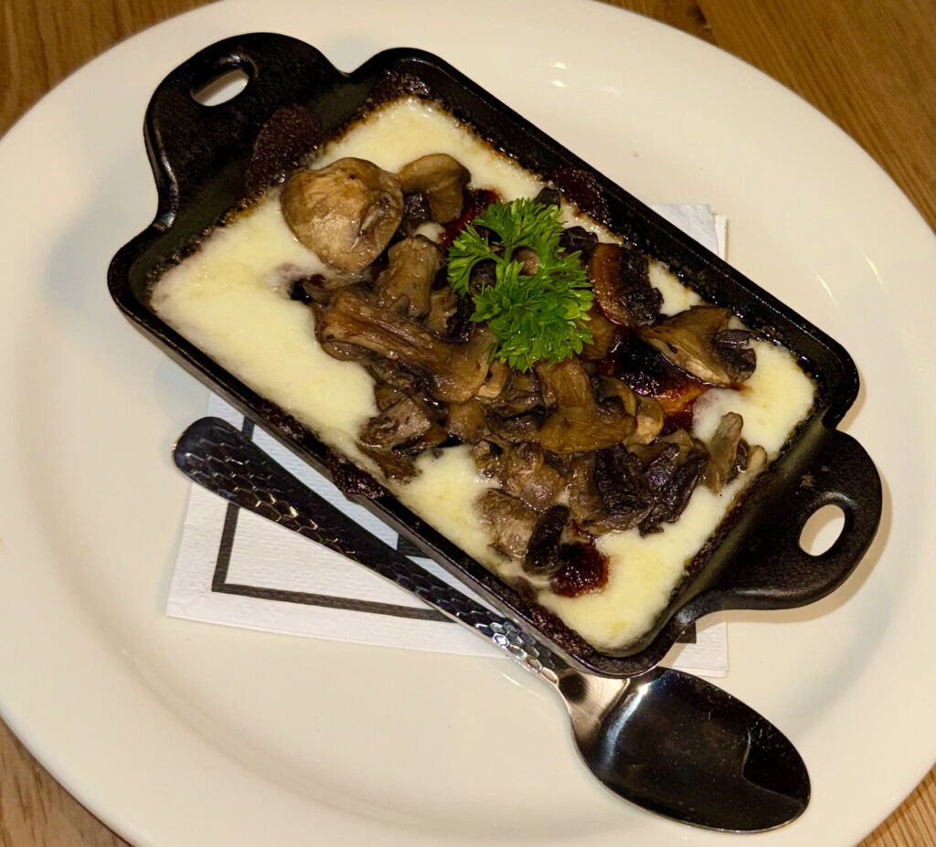 Queso Fundido topped with mushrooms